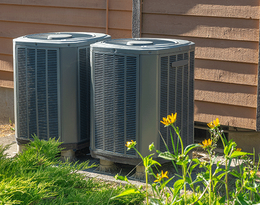 2 heat pumps outside of a building in central indiana