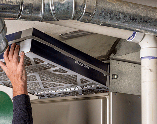 an hvac technician working on a furnace repair in indianapolis